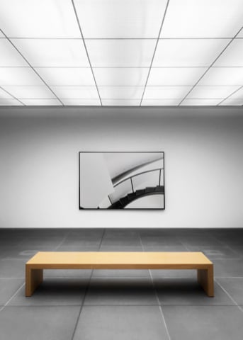 Large art gallery room with a wooden bench